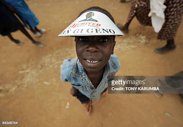 Villagers of Nyang'oma wears a paper hat with a message reading 'We have Hope' ahead of the inauguration of US President-elect Barack Obama on...