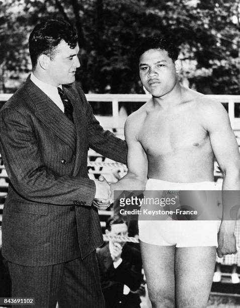 Le champion du monde Jimmy Braddock souhaite un joyeux anniversaire à son plus sérieux adversaire Joe Louis en 1936 aux Etats-Unis.