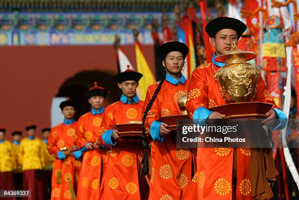 Performers dressed in the costumes of former eunuchs rehearse their steps during an imperial rites ceremony to be staged as a tourist attraction...