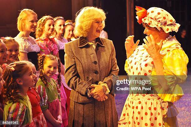 Camilla, Duchess of Cornwall speaks with Dame Trott from pantomime Jack and the Beanstalk, played by Chris Harris, who also directs the panto, during...