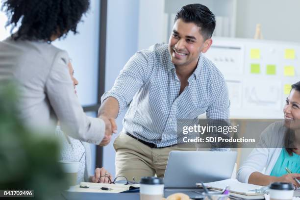 confident businessman greets ceo - woman vice president stock pictures, royalty-free photos & images