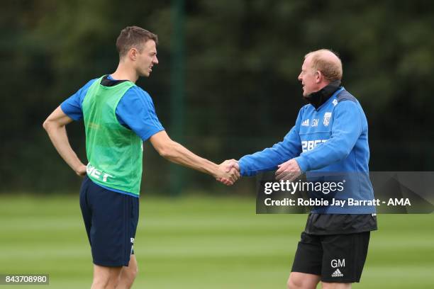 Jonny Evans of West Bromwich Albion and Gary Megson assistant head coach / manager of West Bromwich Albion on September 7, 2017 in West Bromwich,...