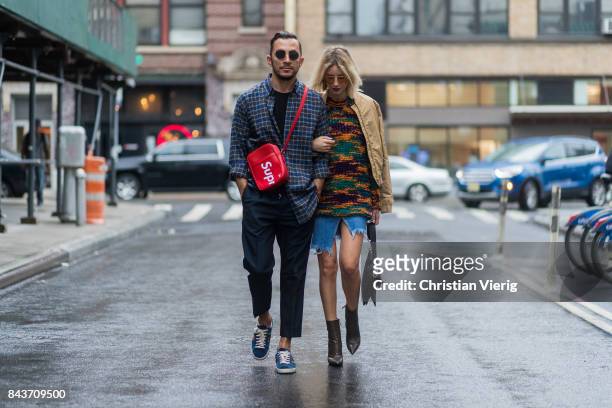 Couple Dima wearing Balenciaga shirt, Supreme x Louis Vuitton bag and Lisa Hahnbueck wearing wearing mustard bomber jacket, Missoni sweater, cutted...