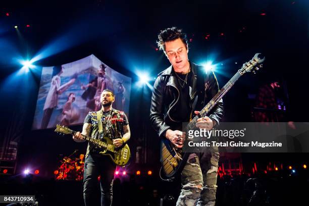 Guitarists Synyster Gates and Zacky Vengeance of American hard rock group Avenged Sevenfold, photographed during a live performance at the O2 Arena...