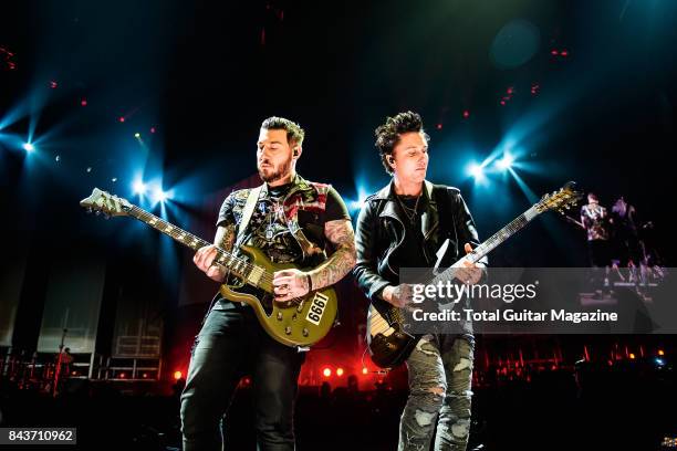 Guitarists Synyster Gates and Zacky Vengeance of American hard rock group Avenged Sevenfold, photographed during a live performance at the O2 Arena...