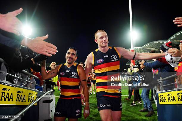 Eddie Betts and Sam Jacobs of the Crows celebrate as they walk from the ground after defeating the Greater Western Sydney Giant during the AFL First...