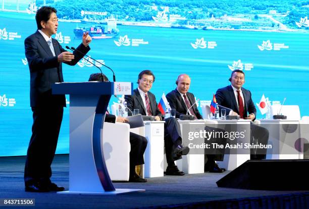 Japanese Prime Minister Shinzo Abe addresses while Hang Lung Properties Chairman Ronnie Chichung Chan, South Korea's President Moon Jae-in, Russia's...