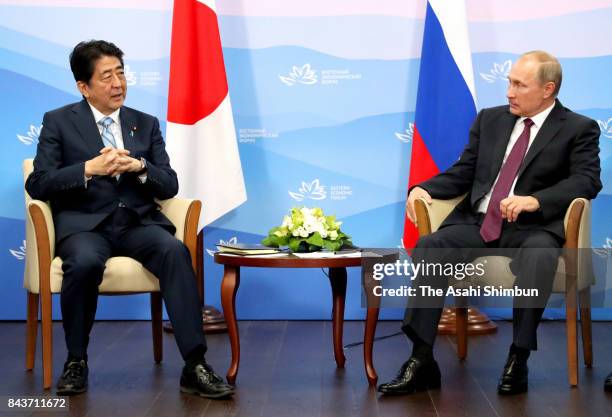 Japanese Prime Minister Shinzo Abe and Russian President Vladimir Putin talk during their bilateral meeting on the sidelines of the Eastern Economic...