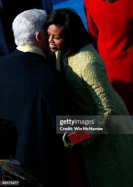 Michelle Obama greets former president Bill Clinton as she arrives at the inauguration of Barack Obama as the 44th President of the United States of...