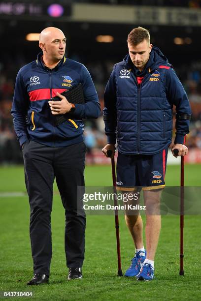 Brodie Smith of the Crows walks from the field with a suspected knee injury after the AFL First Qualifying Final match between the Adelaide Crows and...