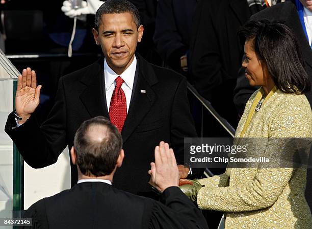 Barack H. Obama is sworn in by Chief Justice John Roberts as the 44th president of the United Statesas on the West Front of the Capitol as his wife...