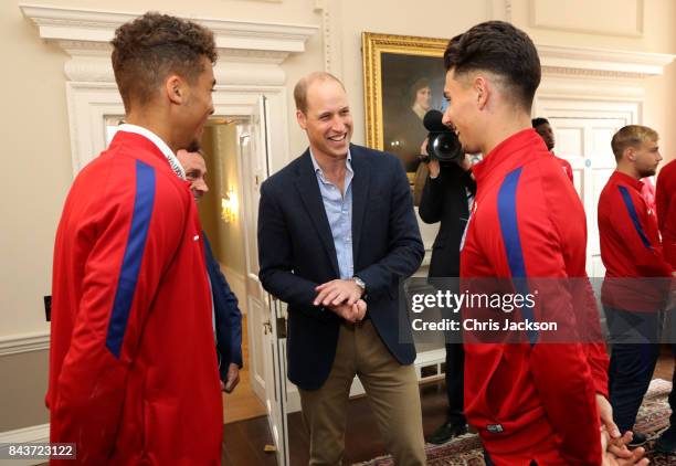 Prince William, Duke of Cambridge President of the Football Association, speaks with Dominic Calvert-Lewin and Luke Southwood during a reception for...