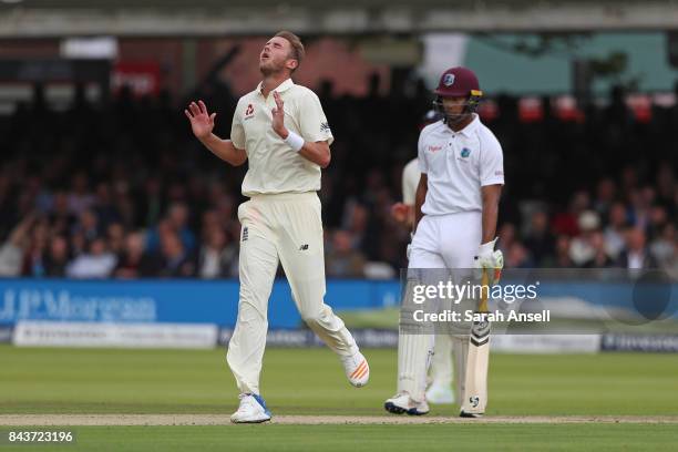 Bowler Stuart Broad of England reacts after a ball narrowly misses the stumps as Kieran Powell of West Indies looks on during day one of the 1st...