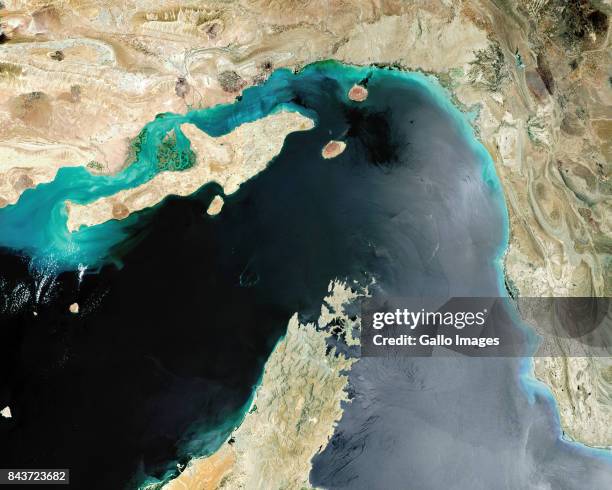 Satellite image of the Strait of Hormuz, a strategic maritime choke point with Iran situated at the top with Qeshm Island and the United Arab...