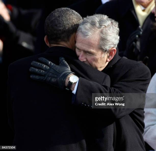 President Barack Obama shakes hugs president George W. Bush as vice-president Dick Cheney looks on during Obama's inauguration as the 44th President...