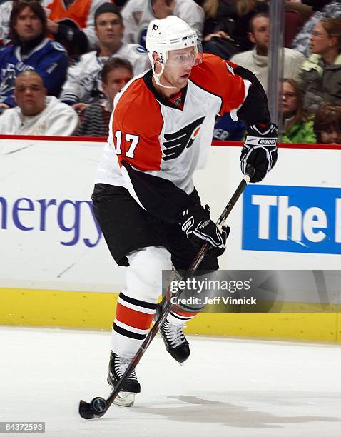 Jeff Carter of the Philadelphia Flyers skates up ice with the puck during the game against the Vancouver Canucks at General Motors Place on December...