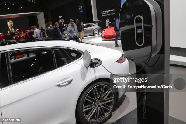 Concept electric vehicle from automaker Porsche is plugged in and charging at the 2017 New York International Auto Show Press Day at Jacob K Javits...