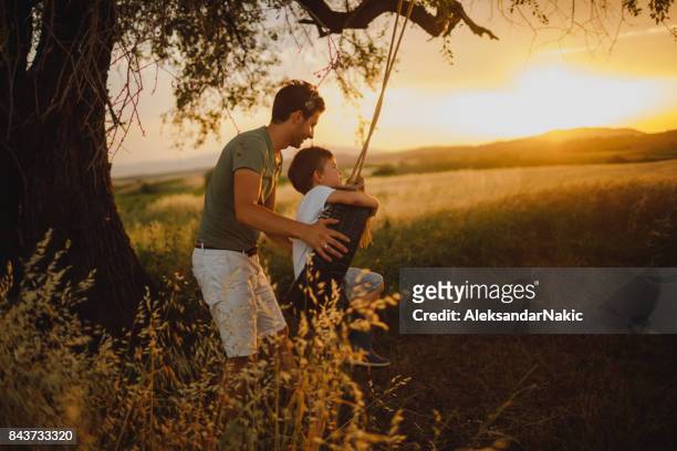 me, dad and a tire swing - tyre swing stock pictures, royalty-free photos & images