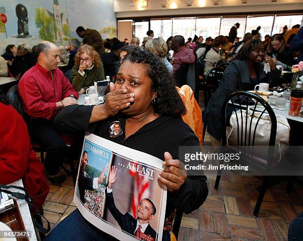 Brenda Clay cries as she listens to Barack Obama being sworn in as the 44th president of the United States, at Valois Cafeteria, purported to be...