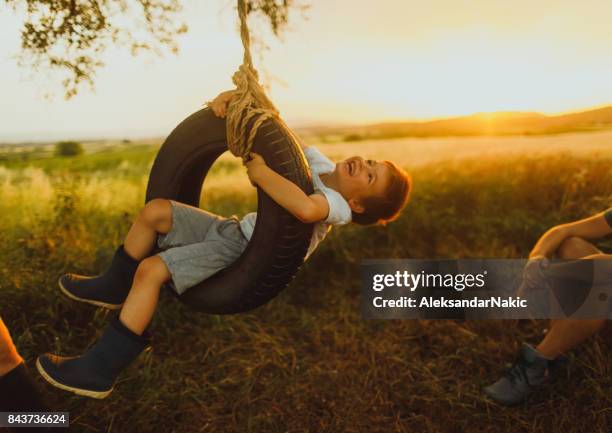 nature loving family - tyre swing stock pictures, royalty-free photos & images