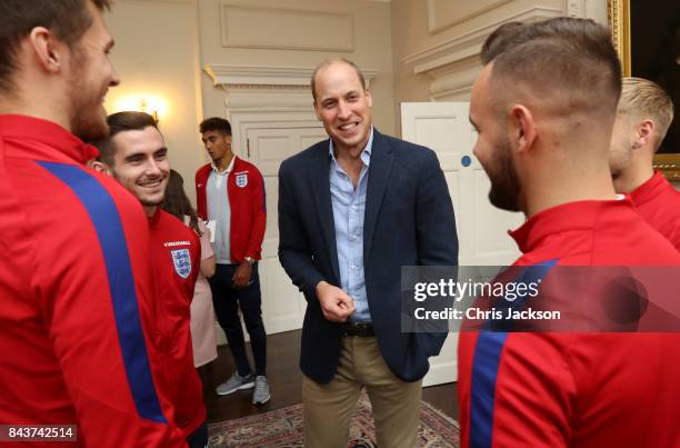 Prince William, Duke of Cambridge, President of the Football Association, speaks with players as he hosts a reception for the Under-20 England...