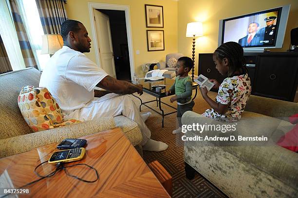 LeBron James of the Cleveland Cavaliers watches with his children, Bryce and LeBron Jr., the Inauguration of the 44th President of the United States,...