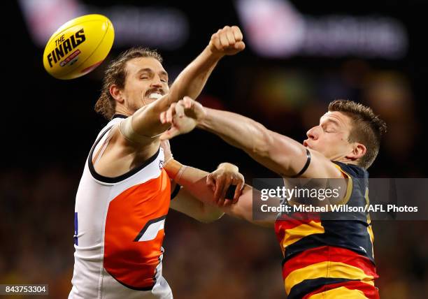 Phil Davis of the Giants and Josh Jenkins of the Crows compete for the ball during the AFL First Qualifying Final match between the Adelaide Crows...