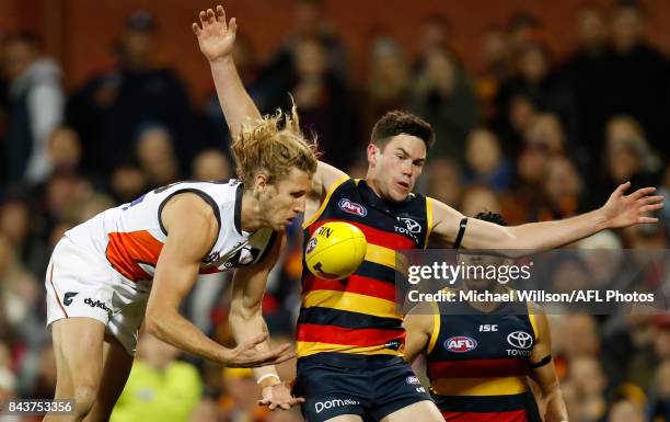 Nick Haynes of the Giants and Mitch McGovern of the Crows compete for the ball during the AFL First Qualifying Final match between the Adelaide Crows...