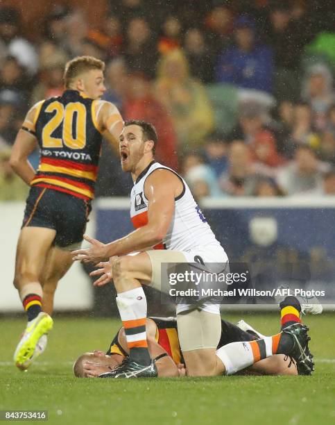 Shane Mumford of the Giants tackles Sam Jacobs of the Crows during the AFL First Qualifying Final match between the Adelaide Crows and the Greater...