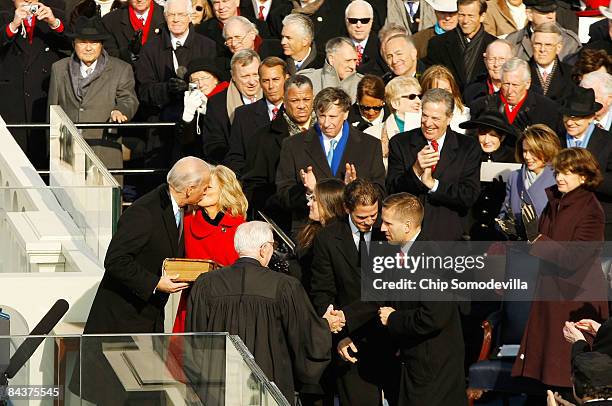 Vice President-elect Joseph R. Biden kisses his wife Jill after being sworn in by Supreme Court Justice John Paul Stevens during the inauguration of...