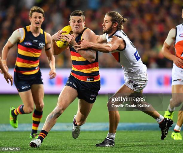 Brad Crouch of the Crows evades a tackle from Sam J. Reid of the Giants during the AFL First Qualifying Final match between the Adelaide Crows and...