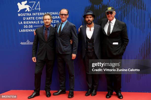 Claudio Santamaria and Marco D'Amore walk the red carpet ahead of the 'Brutti E Cattivi' screening during the 74th Venice Film Festival at Sala...