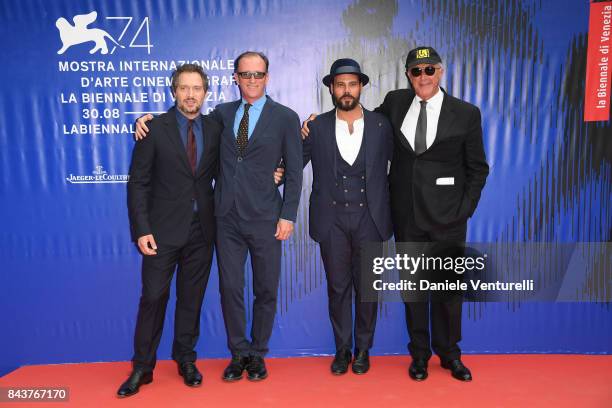 Claudio Santamaria and Marco D'Amore walk the red carpet ahead of the 'Brutti E Cattivi' screening during the 74th Venice Film Festival at Sala...