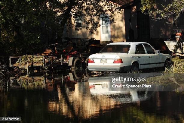 An abandoned car sits in high water along a street in Orange as Texas slowly moves toward recovery from the devastation of Hurricane Harvey on...