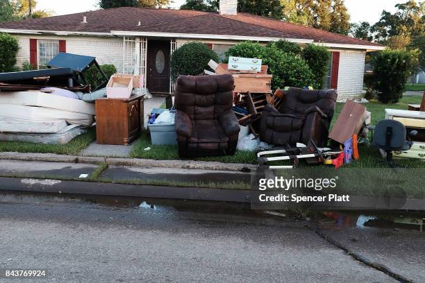 Discarded furniture and other household items sit on the curb outside of a flooded home in Orange as Texas slowly moves toward recovery from the...