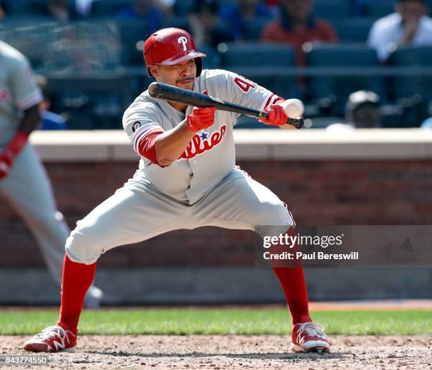 Pitcher Jesen Therrien of the Philadelphia Phillies bunts in an MLB baseball game against the New York Mets on September 4, 2017 at CitiField in the...
