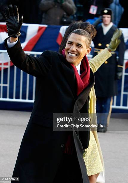 President Barack Obama and first lady Michelle Obama arrive at the Presidential Reviewing Stand during the Inaugural Parade January 20, 2009 in...