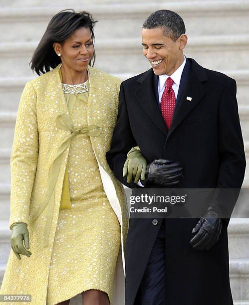 First lady Michelle Obama and President Barack Obama descend the steps from the U.S. Capitol after the inauguration of Barack Obama as the 44th...