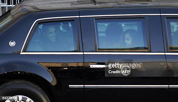 President Barack Obama sits in his limousine during the inaugural parade in Washington, DC, on January 20, 2009.Malia Obama is at right. AFP...