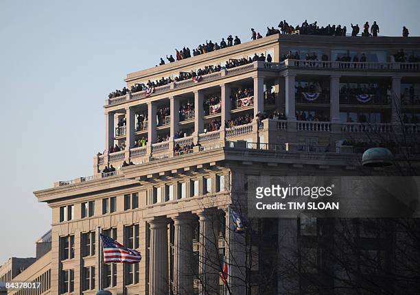 People crowd the roof of a Washington, DC, building as they watch the inaugural parade for US President Barack Obama. AFP PHOTO/TIM SLOAN