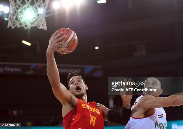 Janos Eilingsfeld of Hungary vies with Willy Hernangomez of Spain during Group C of the FIBA Eurobasket 2017 mens basketball match between Hungary...