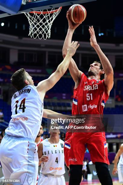 Serbia's center Boban Marjanovic goes to the basket despite Belgium's power forward Maxime De Zeeuw during the men's FIBA Eurobasket 2017 group D...
