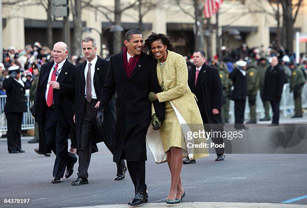 President Barack Obama and first lady Michelle Obama walk in the inaugural parade following his inauguration as the 44th President of the United...