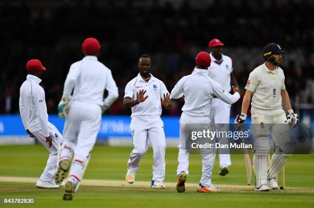 Kemar Roach of the West Indies celebrates taking the wicket of Mark Stoneman of England during day one of the 3rd Investec Test Match between England...