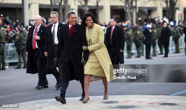 President Barack Obama and first lady Michelle Obama walk in the inaugural parade following his inauguration as the 44th President of the United...