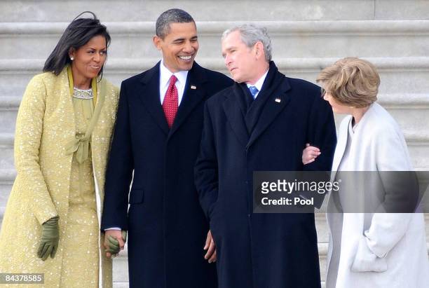Former U.S. President George W. Bush , his wife Laura stand with President Barack Obama and first lady Michelle Obama as Bush departs from the U.S....
