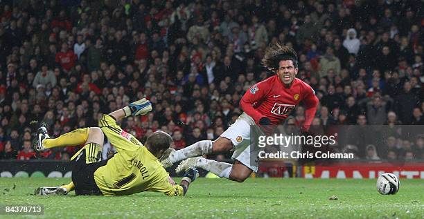 Carlos Tevez of Manchester United clashes with Roy Carroll of Derby County to win a penalty during the Carling Cup Semi-Final 2nd Leg match between...