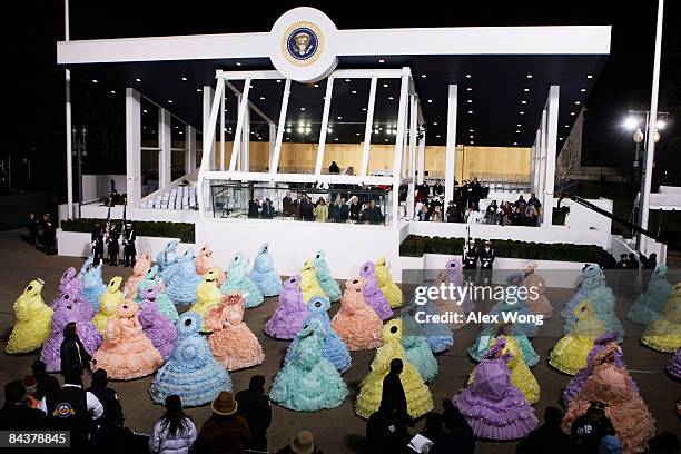 Parade participants walk past the Presidential Reviewing Stand as US President Barack Obama and First Lady Michelle Obama watch the Inaugural Parade...