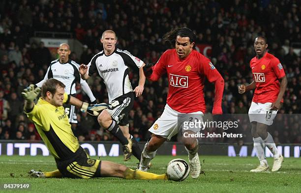 Carlos Tevez of Manchester United clashes with Roy Carroll of Derby County to win a penalty during the Carling Cup Semi-Final 2nd Leg match between...
