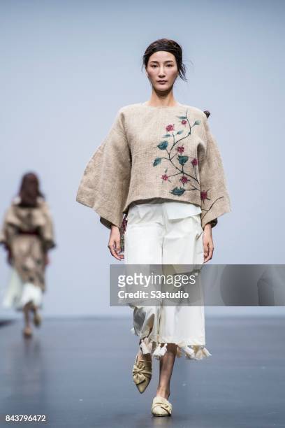 Model showcases designs by Sarah Devina Susanto on the runway during the Redress: The EcoChic Design Award 2017: Grand Final Fashion Show on the Day...